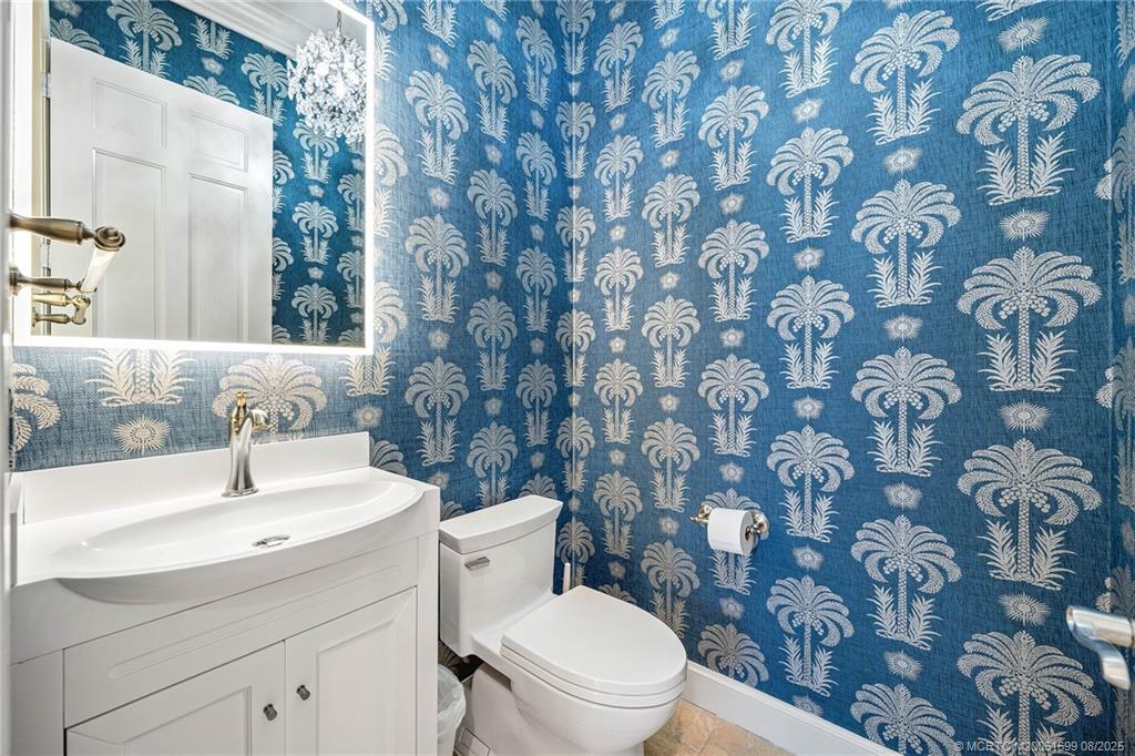 7000 Southeast Lakeview Terrace Stuart, FL 34996 - Photo 21 of 56 a bathroom with a toilet sink and mirror