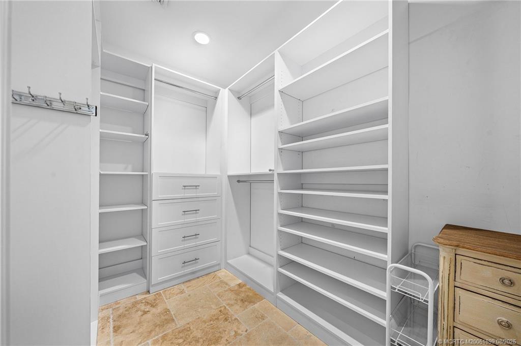 7000 Southeast Lakeview Terrace Stuart, FL 34996 - Photo 22 of 56 a view of walk in closet with empty racks