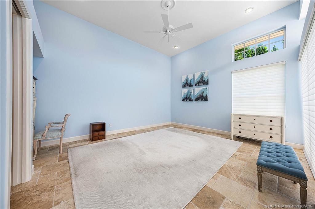 7000 Southeast Lakeview Terrace Stuart, FL 34996 - Photo 24 of 56 a bedroom with a bed and a chair