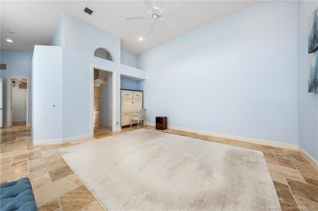 7000 Southeast Lakeview Terrace Stuart, FL 34996 - Photo 25 of 56 a view of an empty room with window and chandelier fan