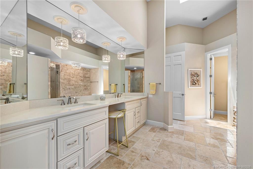 7000 Southeast Lakeview Terrace Stuart, FL 34996 - Photo 27 of 56 a spacious bathroom with a sink a mirror and a shower