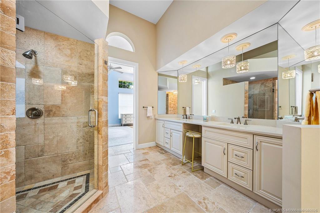 7000 Southeast Lakeview Terrace Stuart, FL 34996 - Photo 28 of 56 a spacious bathroom with a shower sink and mirror