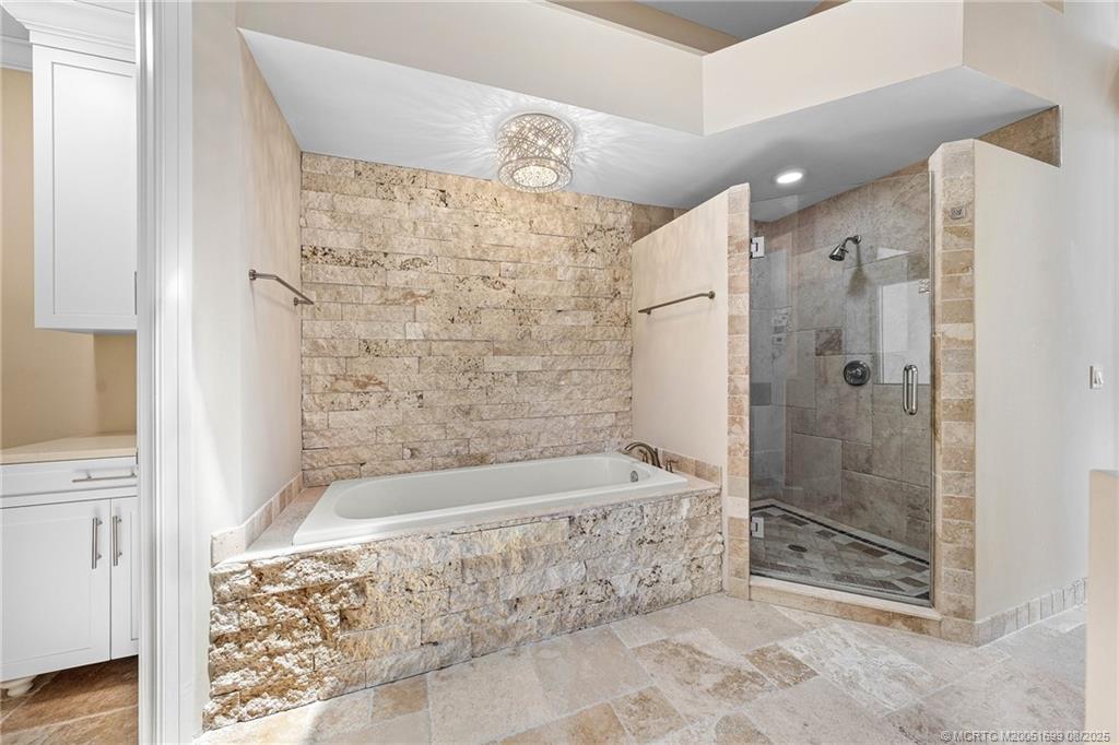 7000 Southeast Lakeview Terrace Stuart, FL 34996 - Photo 29 of 56 a bathroom with a bathtub and shower