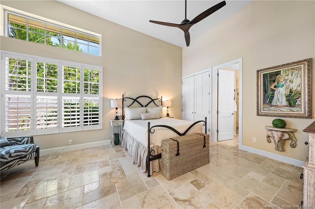 7000 Southeast Lakeview Terrace Stuart, FL 34996 - Photo 31 of 56 a spacious bedroom with a bed a table and chair