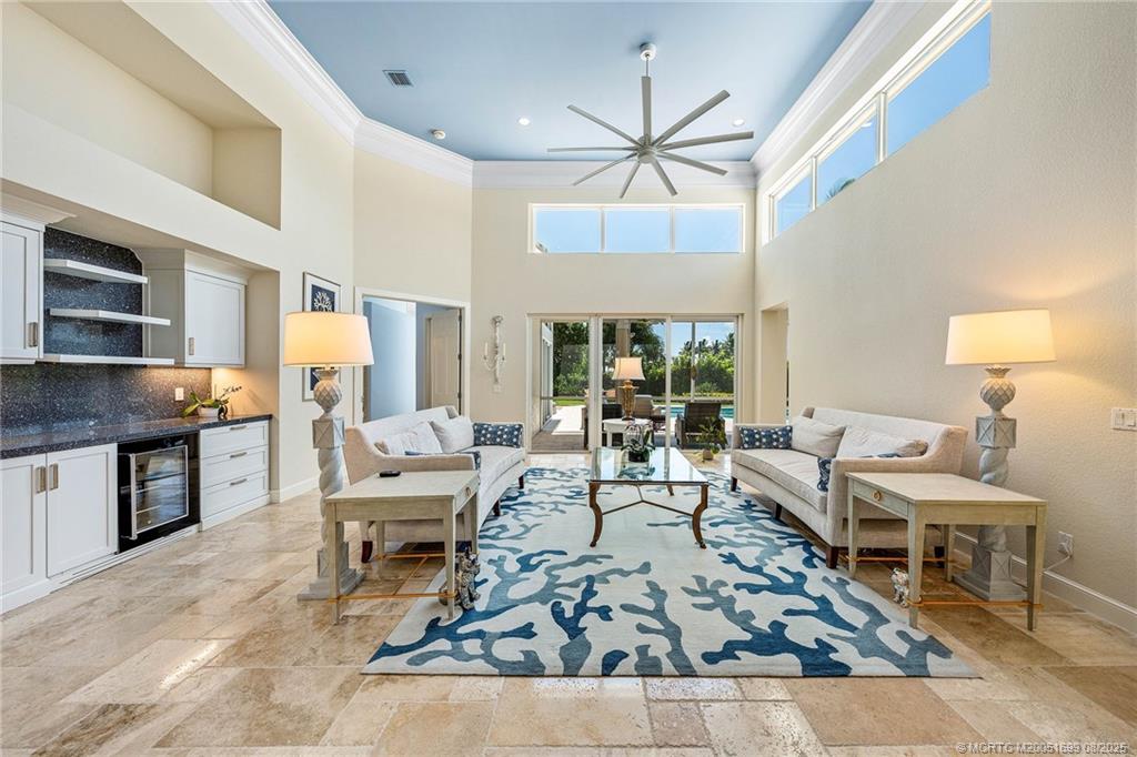7000 Southeast Lakeview Terrace Stuart, FL 34996 - Photo 4 of 56 a living room with furniture and a chandelier