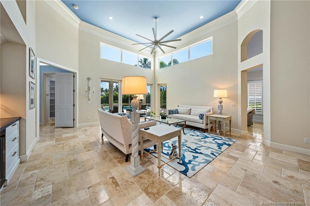7000 Southeast Lakeview Terrace Stuart, FL 34996 - Photo 5 of 56 a living room with furniture a chandelier and a dining table