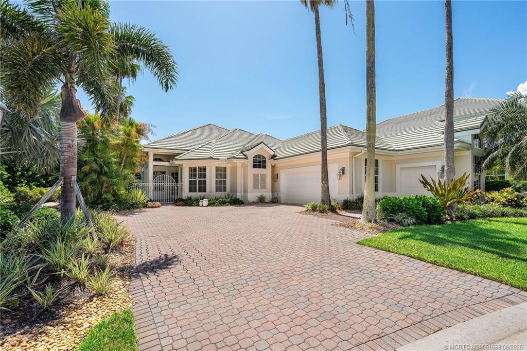 7000 Southeast Lakeview Terrace Stuart, FL 34996 - Photo 52 of 56 a front view of a house with a yard and potted plants