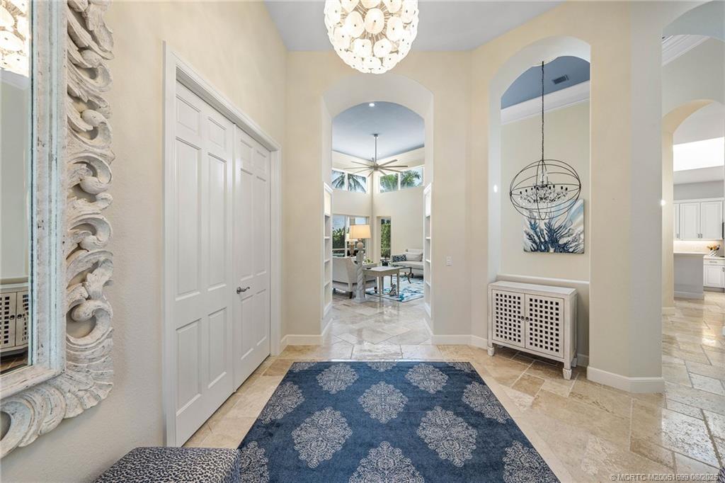 7000 Southeast Lakeview Terrace Stuart, FL 34996 - Photo 7 of 56 a view of a hallway with entryway wooden floor and front door