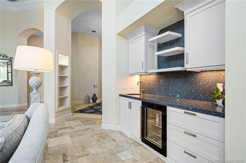 7000 Southeast Lakeview Terrace Stuart, FL 34996 - Photo 10 of 56 a kitchen with a refrigerator and a stove