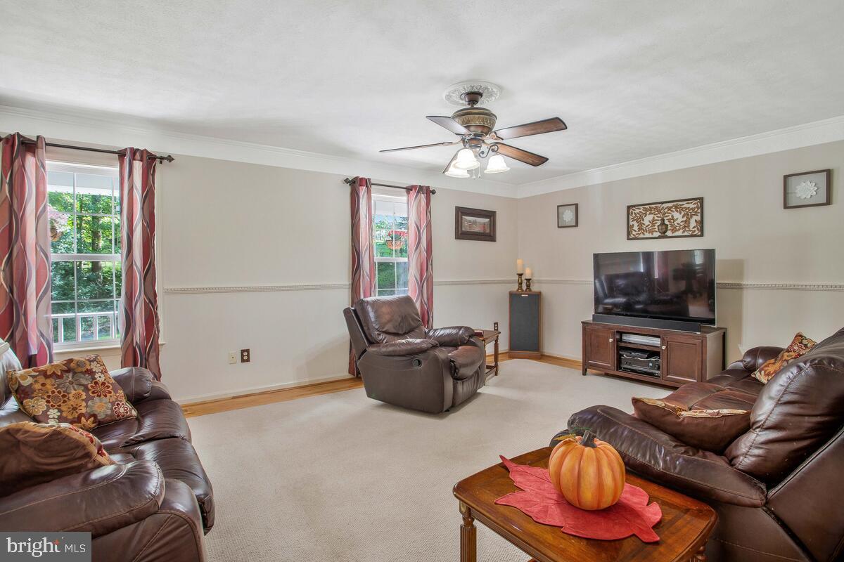 165 Ball Road St. Leonard, MD 20685 - Photo 11 of 55 a living room with furniture and a flat screen tv