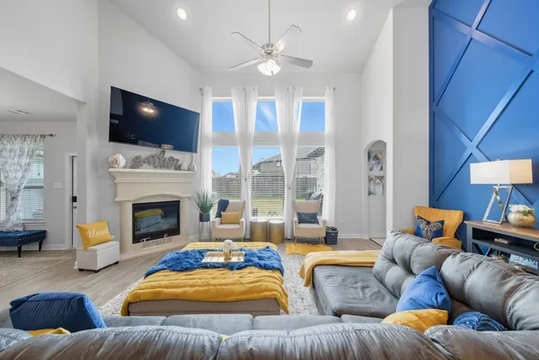 a living room with furniture fireplace and flat screen tv