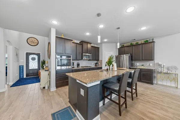 a large kitchen with a table and chairs in it