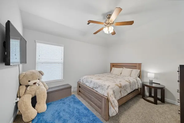 a bedroom with a bed and a window