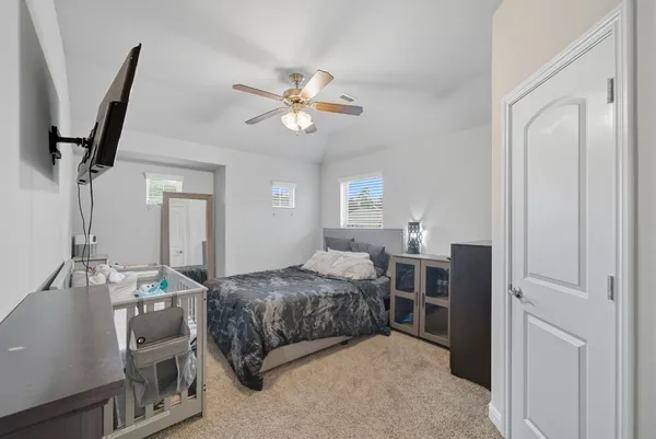 a bedroom with a bed and a chandelier