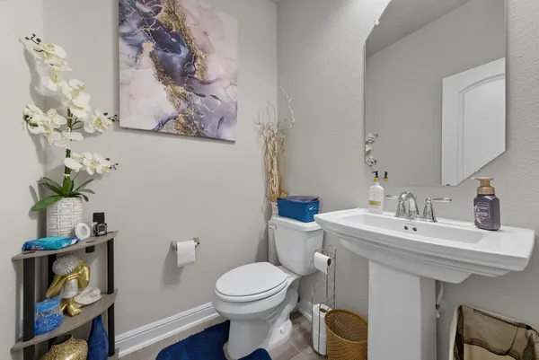 a bathroom with a toilet sink and mirror