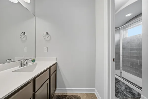 a bathroom with a sink a mirror and a shower