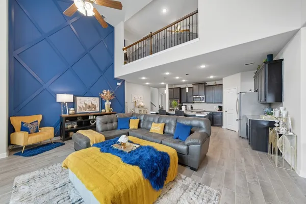 a living room with furniture and a kitchen view