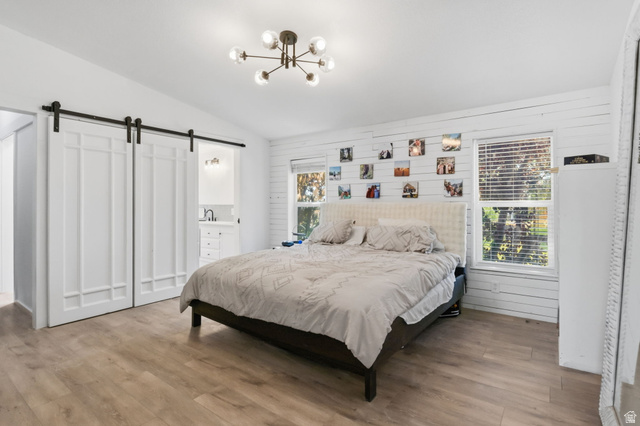 4270 River Road Oakley, UT 84055 - Photo 7 of 46 Spacious room featuring wood-finish flooring, a modern sputnik chandelier, and a white shiplap accent wall
