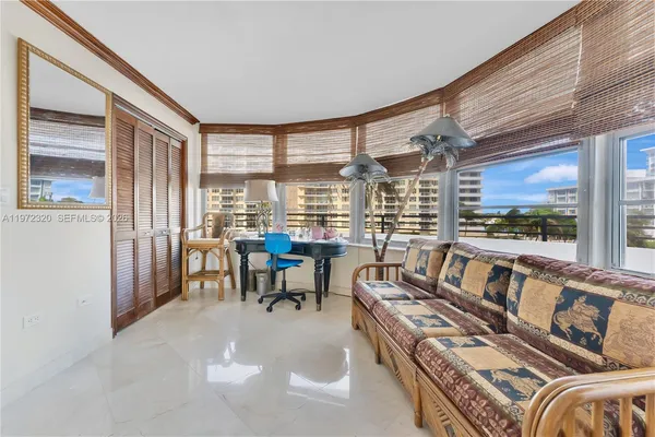 a living room with furniture and a floor to ceiling window