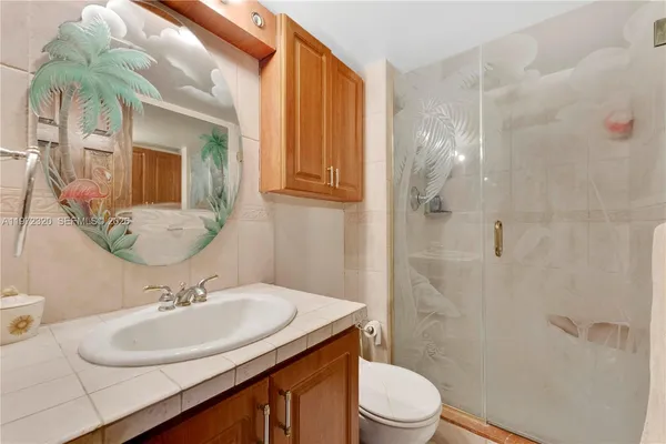 a bathroom with a sink toilet and shower
