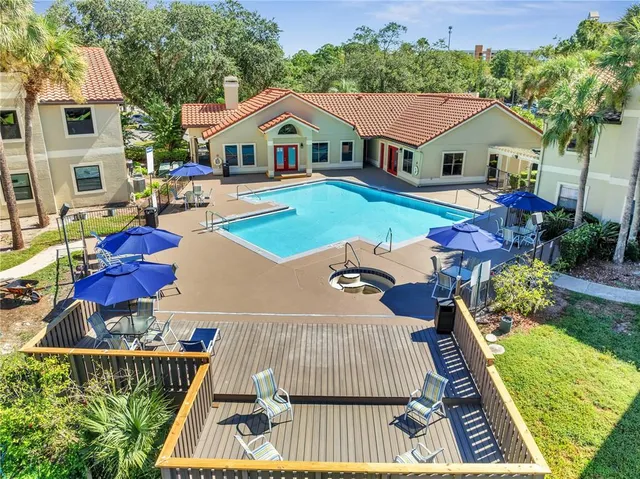 a view of house and outdoor space with swimming pool and furniture