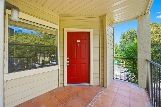 a view of a porch with a red door