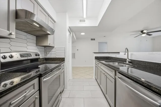 a kitchen with a stove and a sink