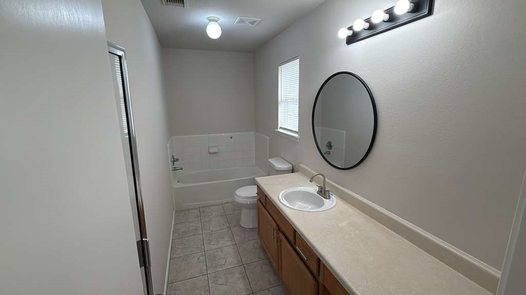 6622 Sutton Meadows Drive Houston, TX 77086 - Photo 25 of 45 a bathroom with a sink a toilet and a mirror