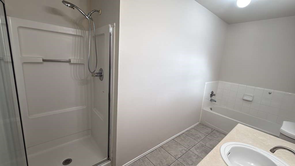 6622 Sutton Meadows Drive Houston, TX 77086 - Photo 26 of 45 a bathroom with a granite countertop toilet and a sink