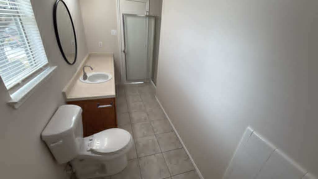6622 Sutton Meadows Drive Houston, TX 77086 - Photo 27 of 45 a bathroom with a toilet and a mirror
