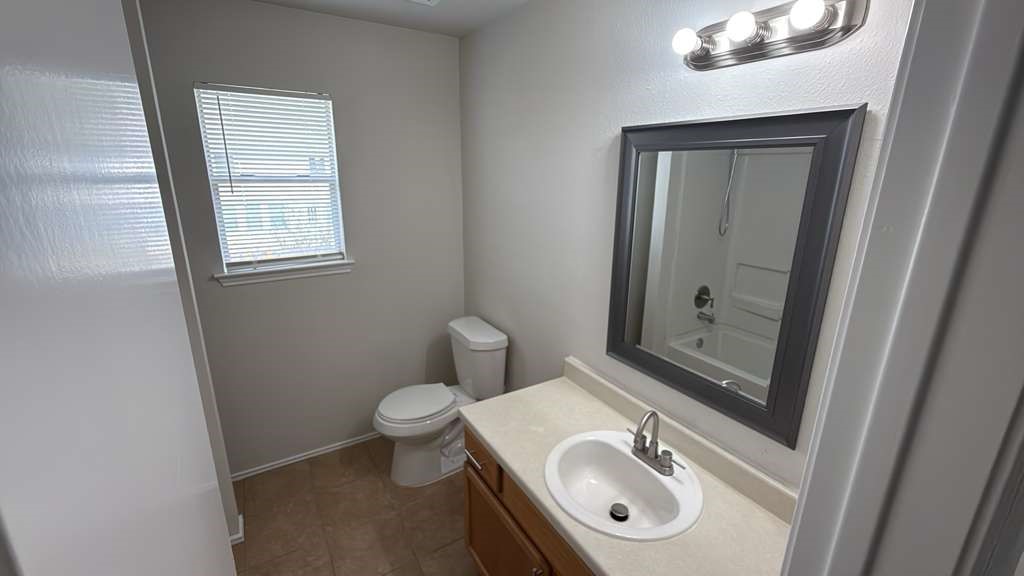 6622 Sutton Meadows Drive Houston, TX 77086 - Photo 30 of 45 a bathroom with a sink a toilet and mirror