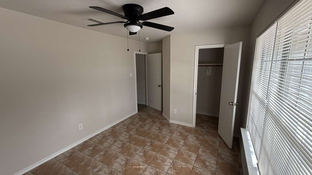 6622 Sutton Meadows Drive Houston, TX 77086 - Photo 39 of 45 a view of a hallway with a chandelier fan and closet
