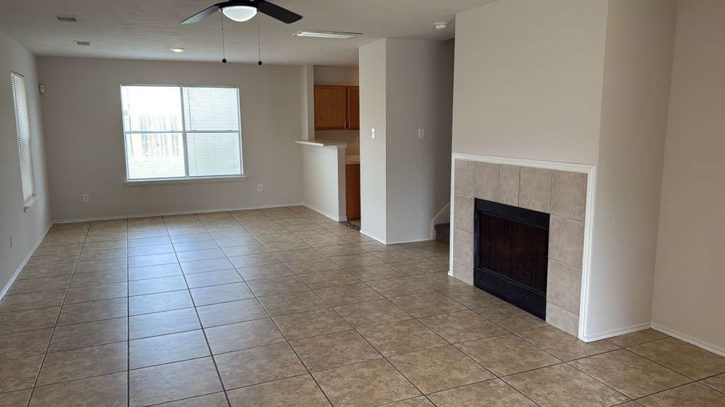 6622 Sutton Meadows Drive Houston, TX 77086 - Photo 5 of 45 an empty room with kitchen and fireplace