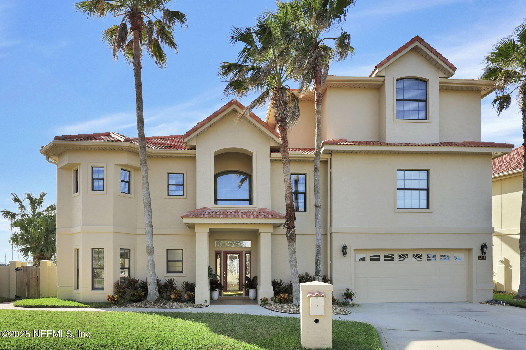 3713 Harbor Drive St. Augustine, FL 32084 - Photo 2 of 48 a front view of a house with a yard and garage