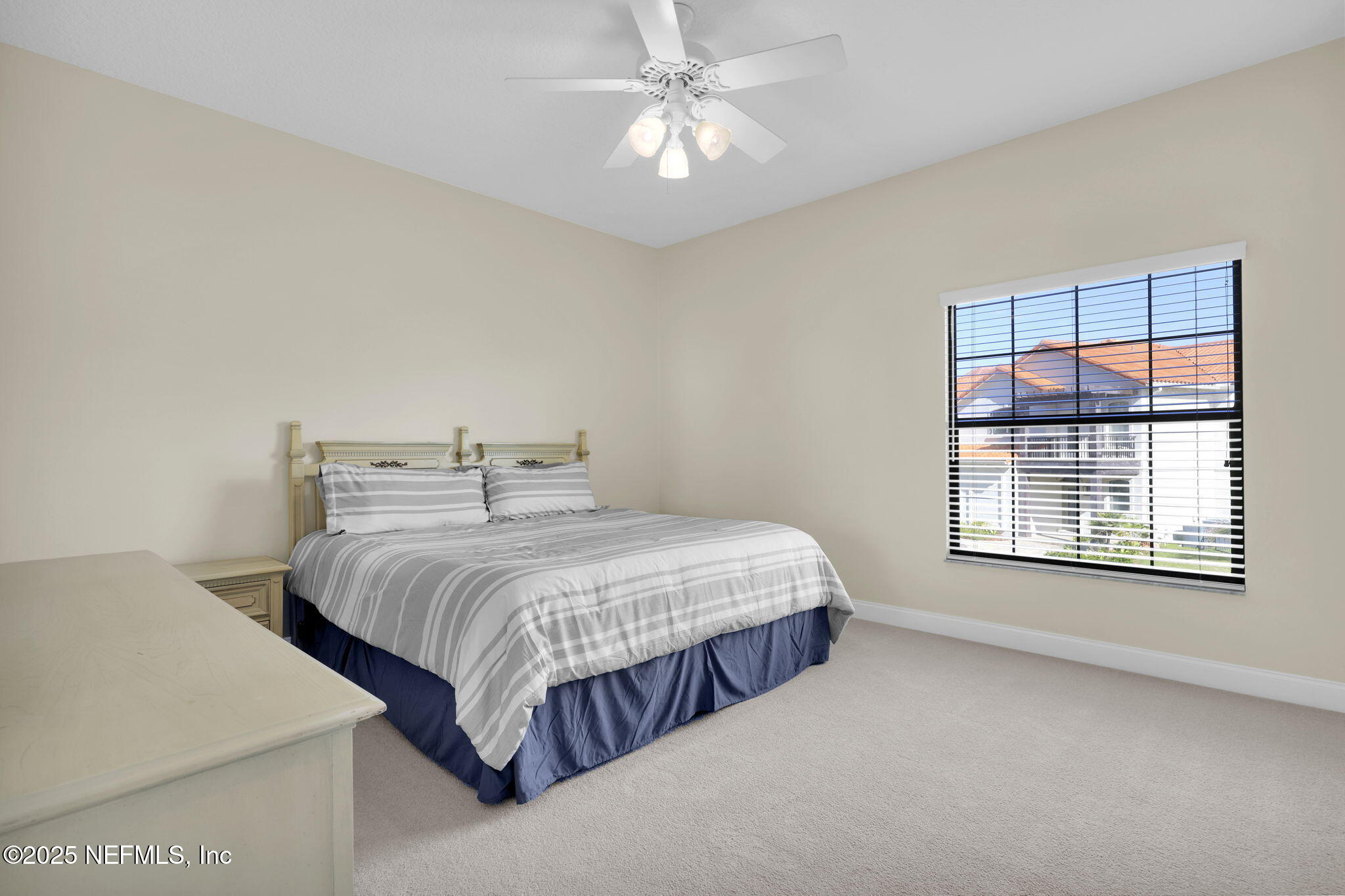 3713 Harbor Drive St. Augustine, FL 32084 - Photo 35 of 48 a bedroom with a bed and a chandelier