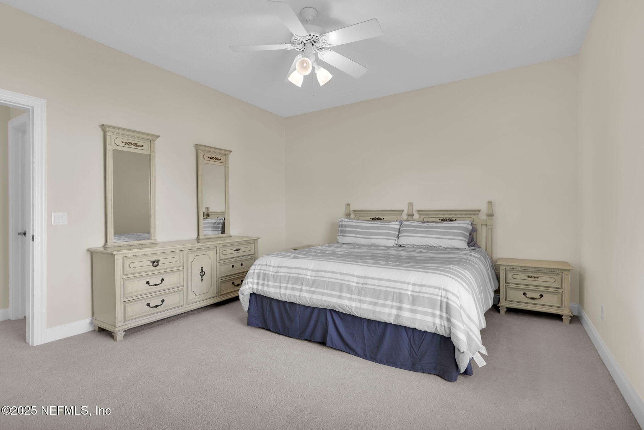 3713 Harbor Drive St. Augustine, FL 32084 - Photo 36 of 48 a bedroom with a bed and a chandelier fan