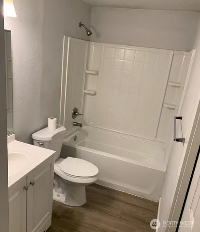 a bathroom with a toilet a sink and shower