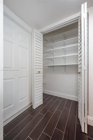 a room with walk in closet and stairs