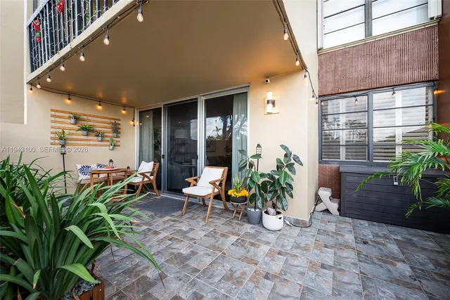 a backyard of a house with table and chairs