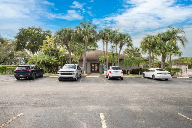 a view of parked cars in front of house