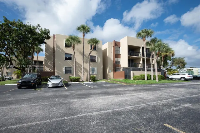 a view of a building with a garden and sitting area