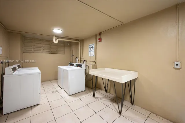 a view of street with sign board and palm trees