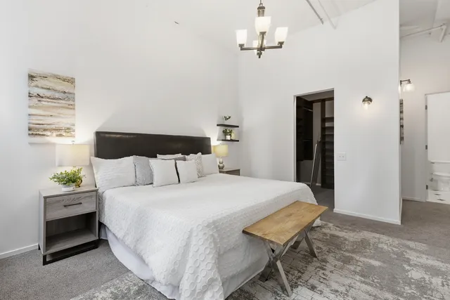 a bedroom with a bed and a chandelier