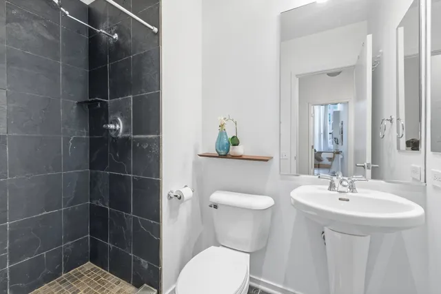 a bathroom with a sink toilet and shower