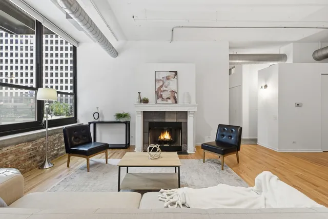 a living room with furniture and a fireplace