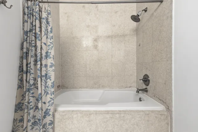 a bath tub sitting next to a shower