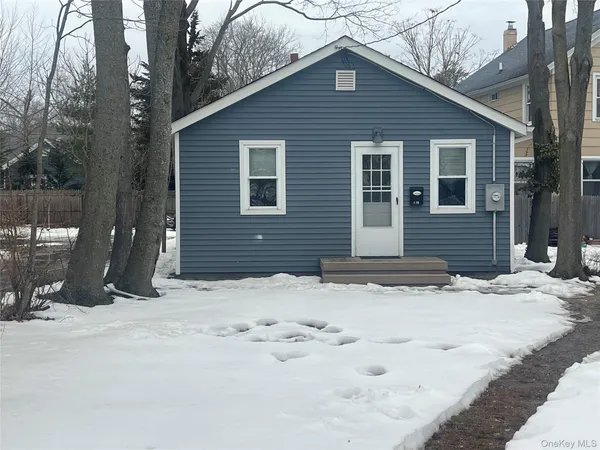 a view of a house with snow on the road