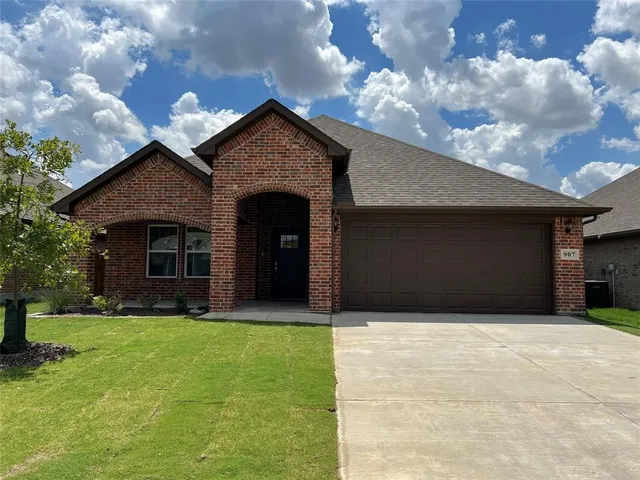 a front view of a house with yard and garage
