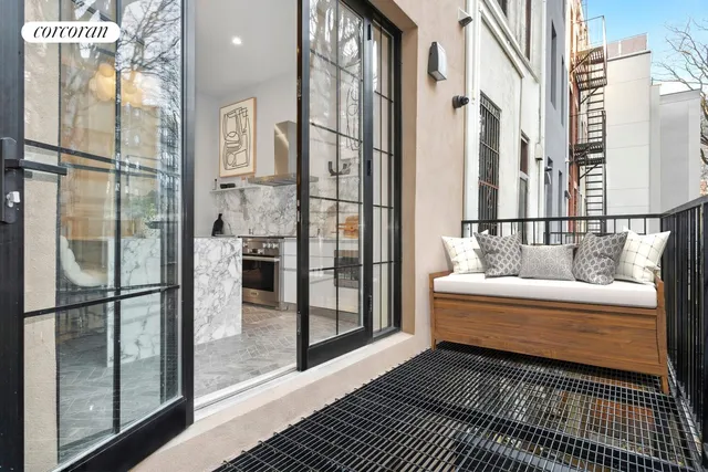 a view of a livingroom with furniture and a window