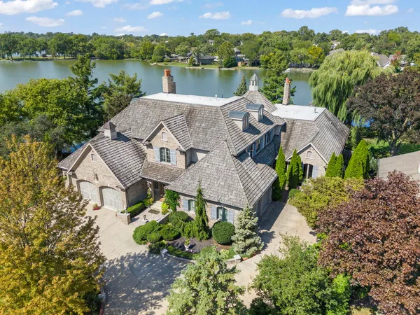 an aerial view of a house with a lake view